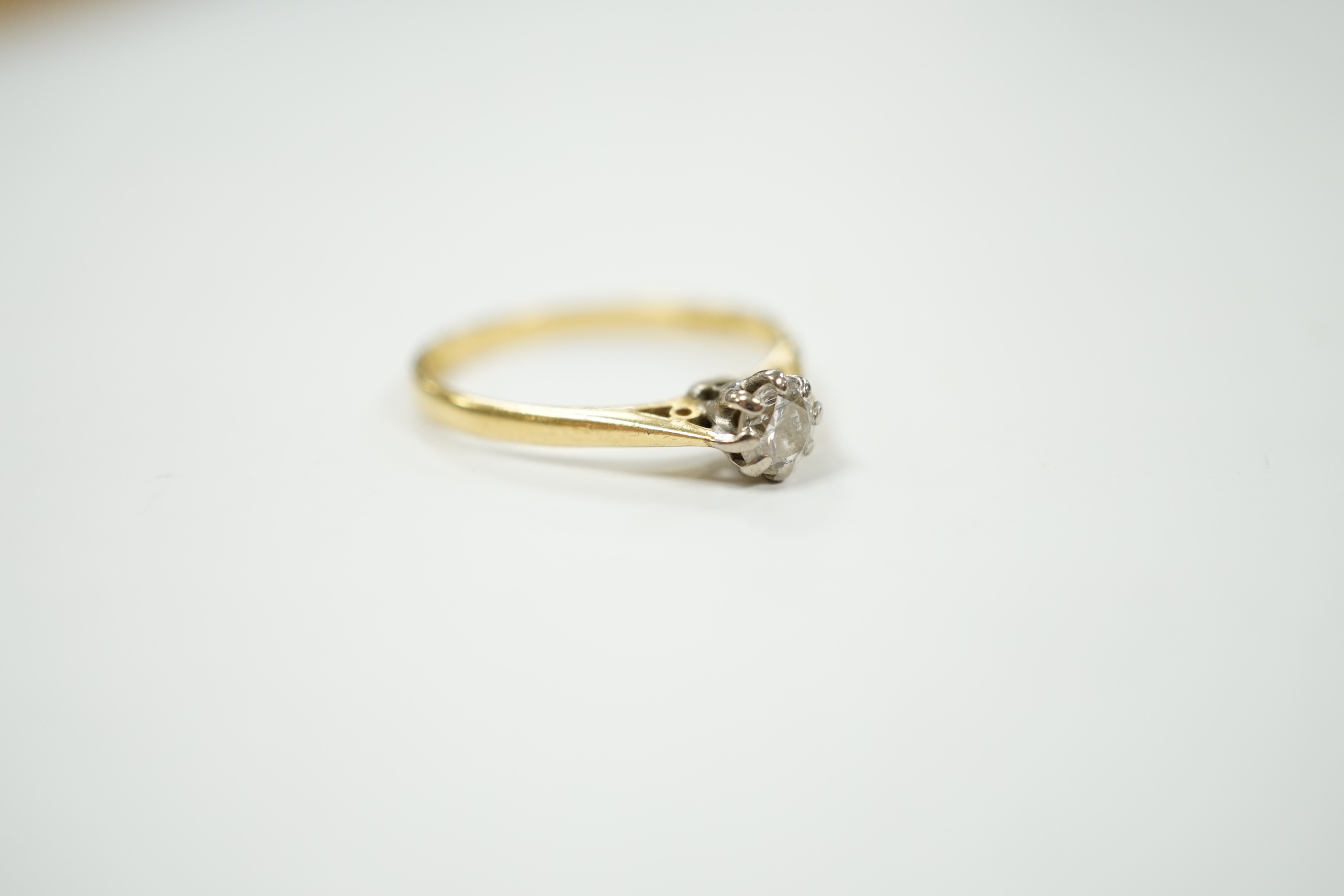 A modern 18ct gold and solitaire diamond set ring, size P/Q, gross weight 2.4 grams, the stone weighing 0.33ct.